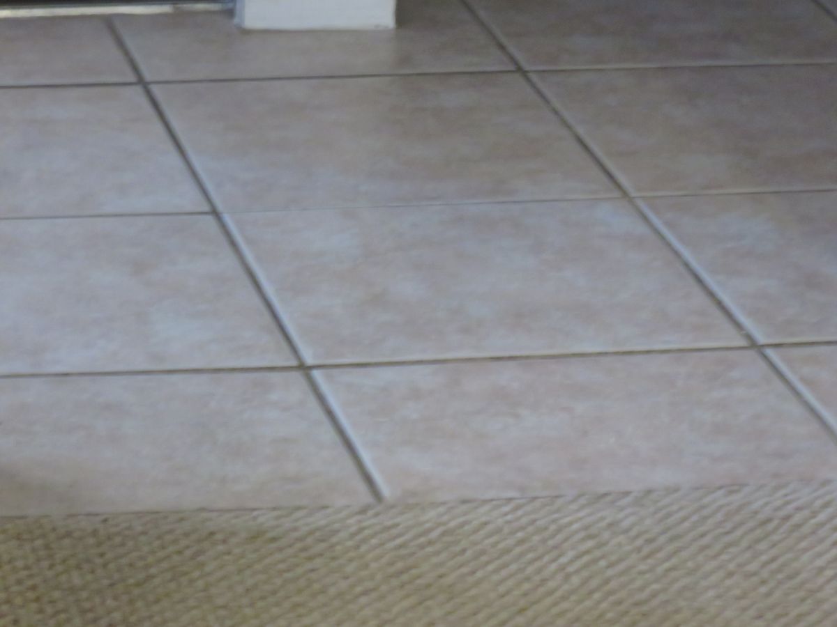 Close-up of tile flooring being laid