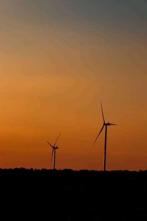 Silhouettes of Windmills on Horizon on Sunset