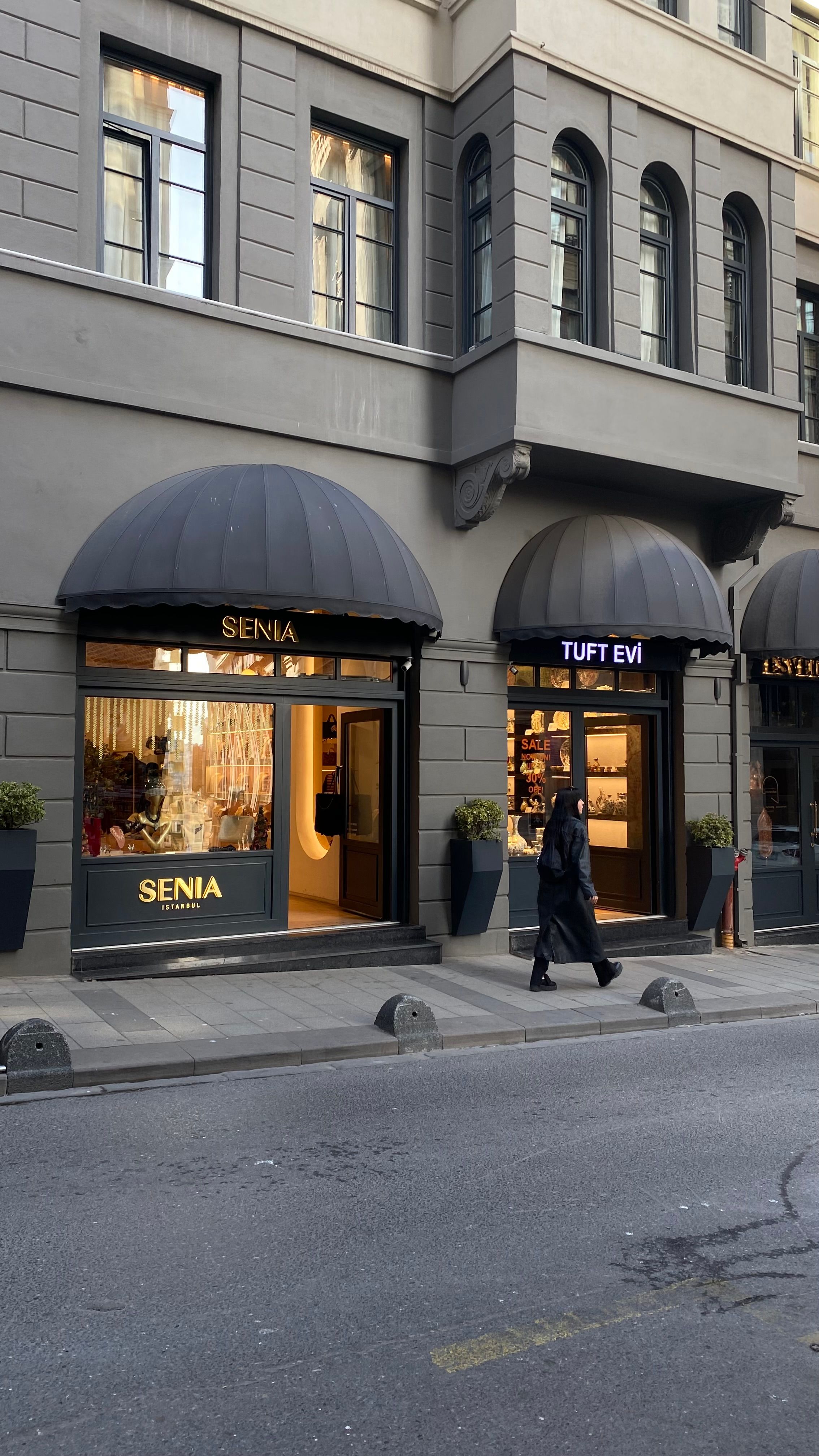 Exterior view of shops on a lively Istanbul street with classic awnings.