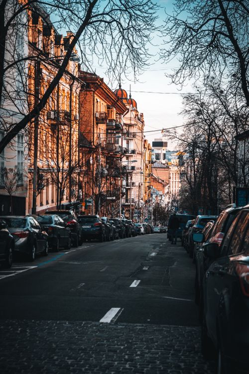 Free Beautiful urban street in Kyiv, Ukraine featuring parked cars, buildings, and a serene atmosphere. Stock Photo