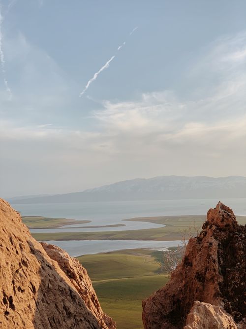 Free Breathtaking view of Qurago's serene landscape featuring mountains and sea under a bright sky. Stock Photo