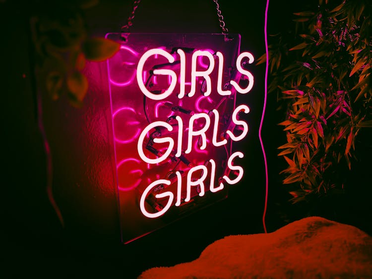 Pink Neon Sign On Wall In Nightclub