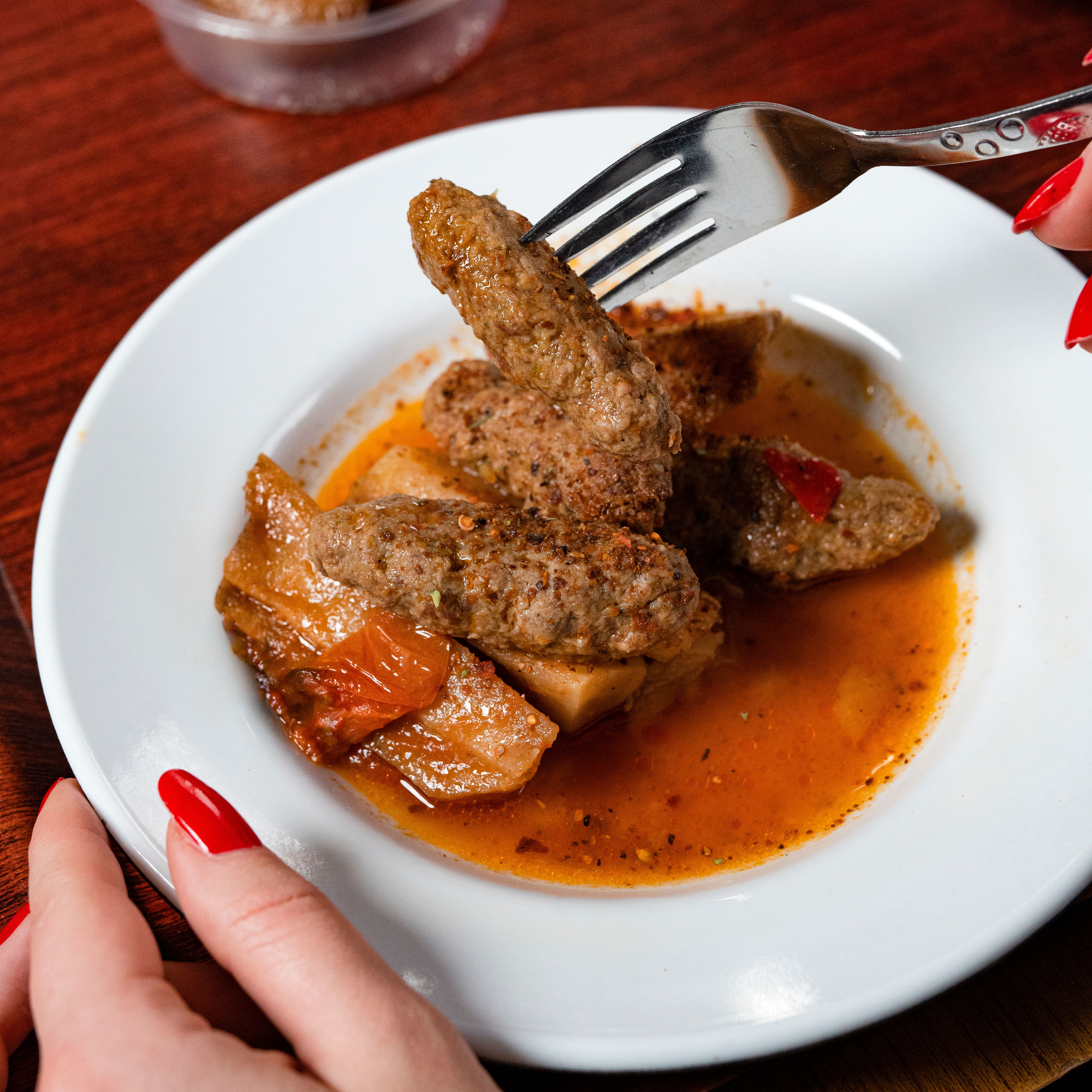 Chef finishing a curry plate with careful plating