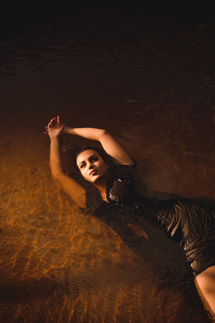 Woman In A Dress Posing In Water 