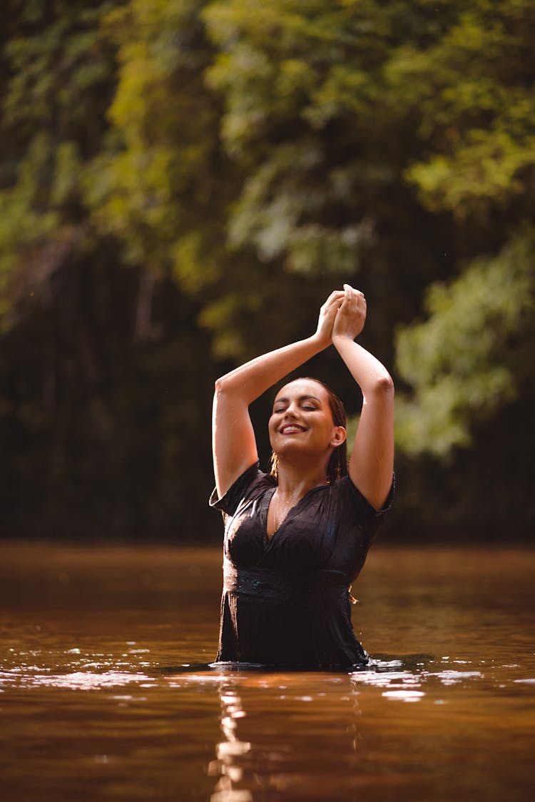 Woman In A Dress Posing In Water 