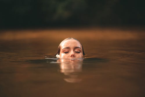 Woman Emerging from Water Surface 