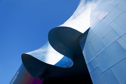 Free Futuristic metal facade of Seattle's iconic architecture against a clear blue sky. Stock Photo