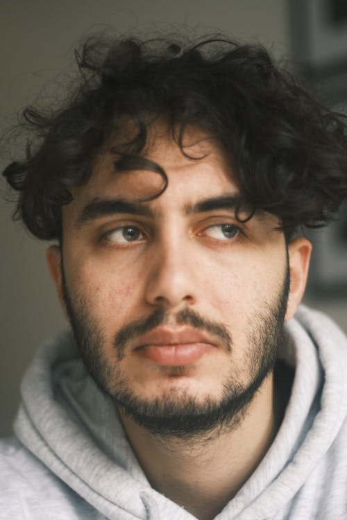 Portrait of a Young Man in a Gray Hoodie 