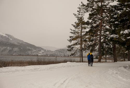Couple Walking by the Lake in Winter 