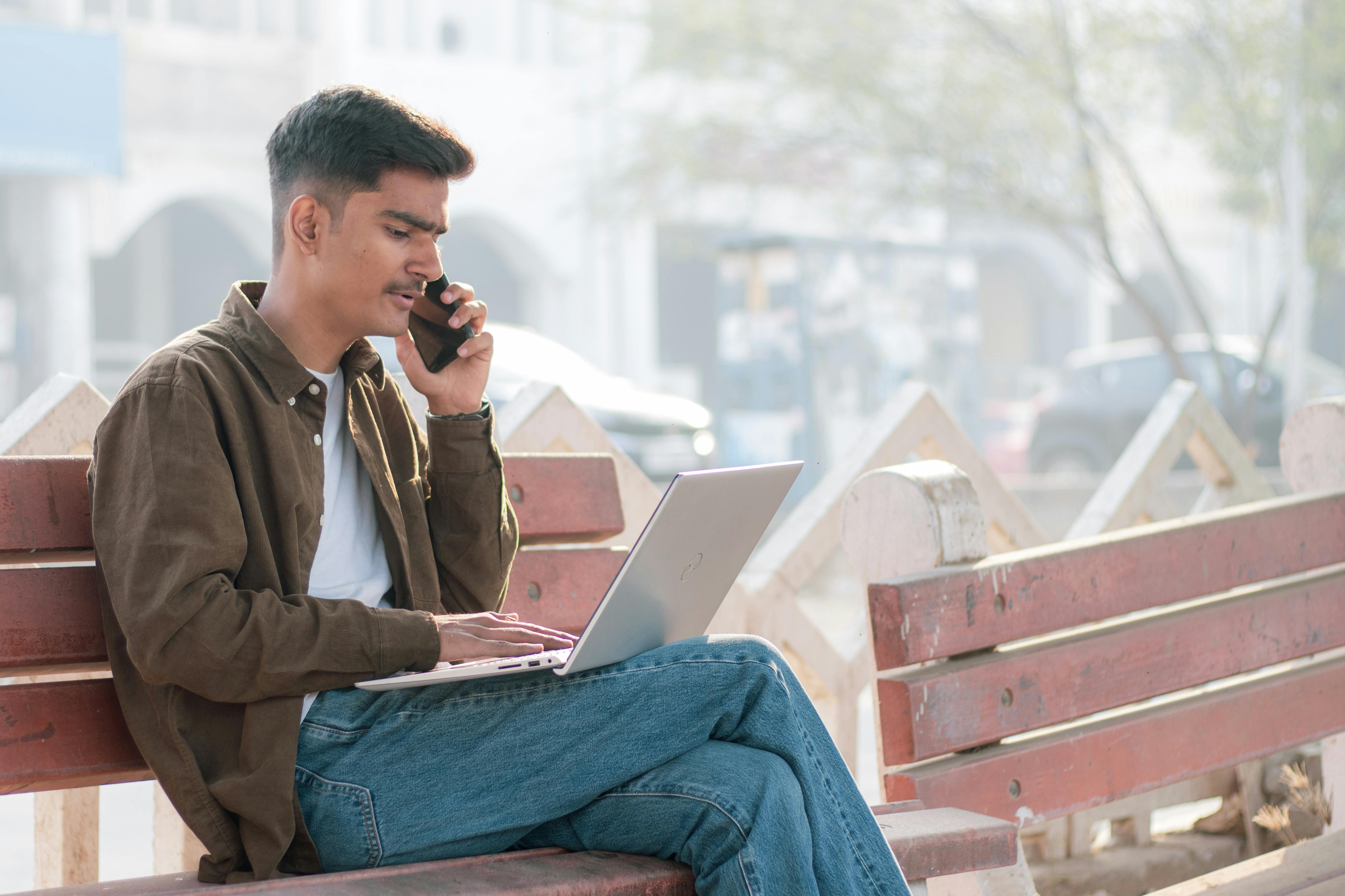 Young Indian boy working on a laptop
