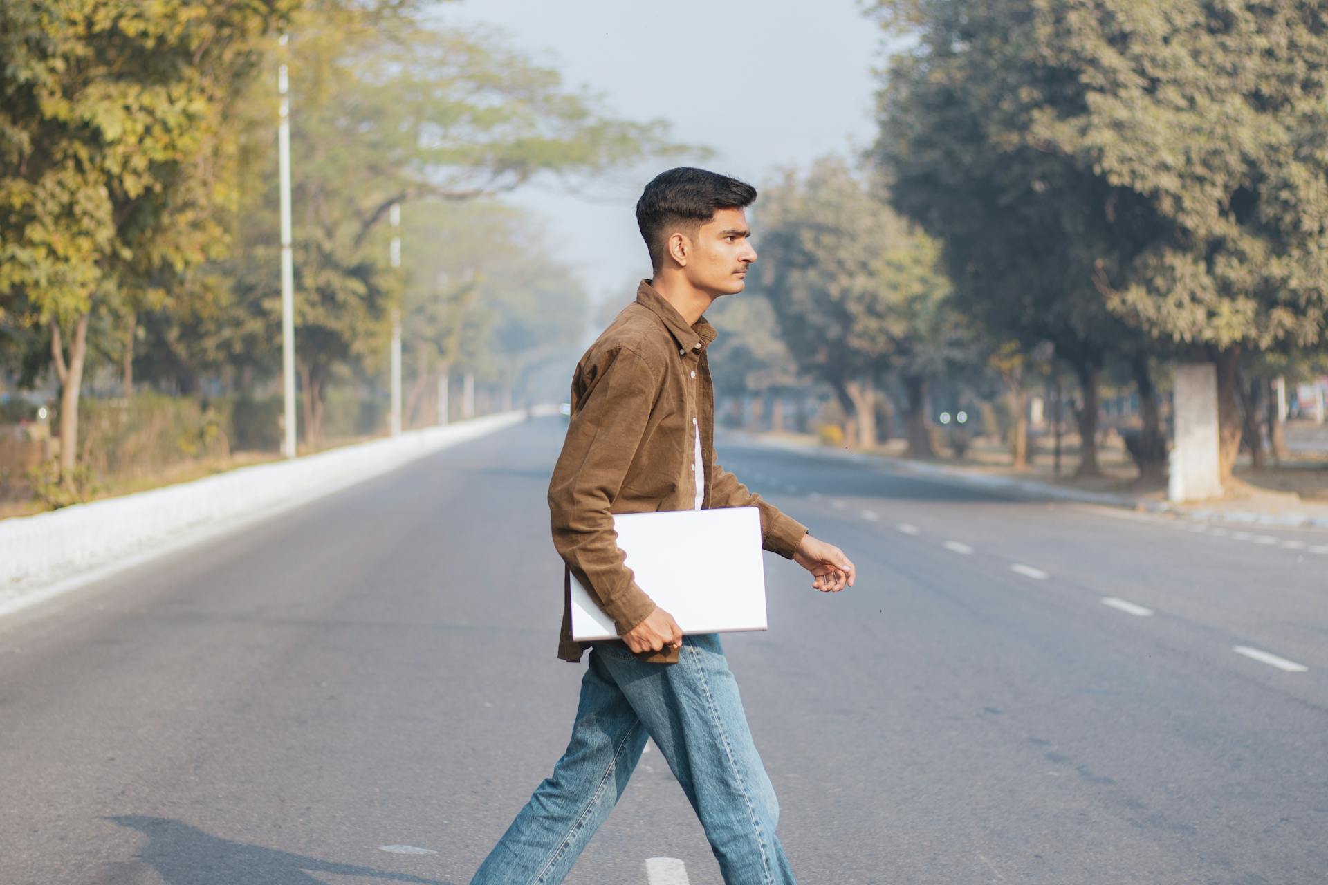 Young indian boy is doing his work in laptop.