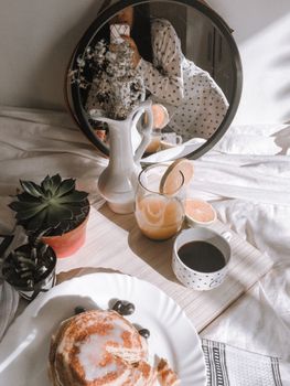 A warm, inviting breakfast scene featuring pancakes, coffee, and orange juice.
