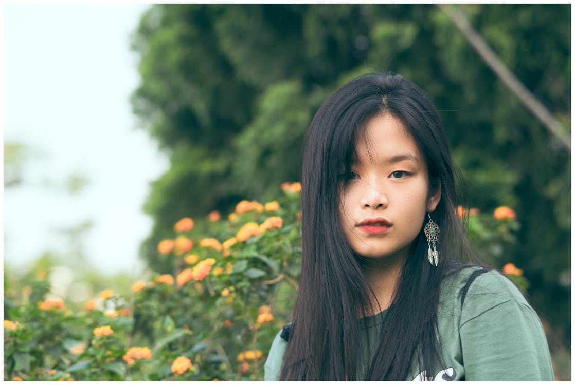 Free Woman Standing Near Orange Flowers Stock Photo