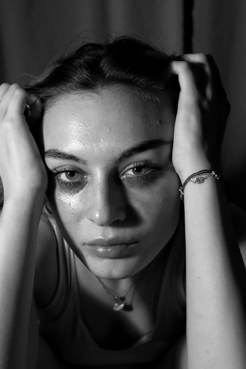 Young Woman with Makeup Smudged under Her Eyes 