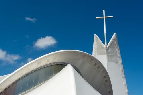 Free A modern church with a cross, featuring sleek architecture under a clear blue sky in Maassluis, Netherlands. Stock Photo