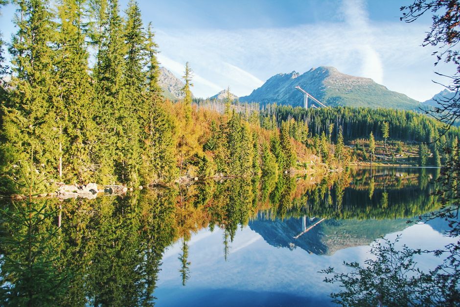 A tourist holding a Tatry Card in the High Tatras region of Slovakia, ready for adventure
