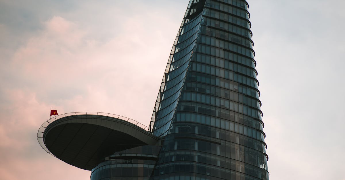 The iconic Bitexco Financial Tower stands tall against a cloudy Ho Chi Minh skyline.