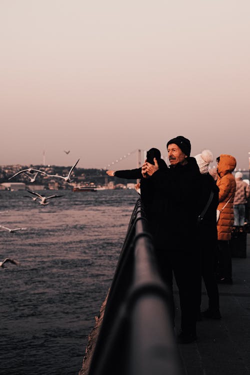 People Standing on a Pier 