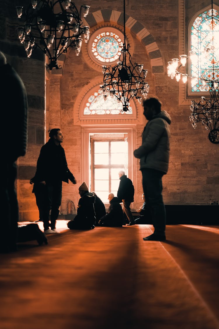 Silhouette Of People Praying In A Mosque