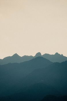 Tranquil mountain silhouette with a soft gradient sky, ideal for nature-themed projects.