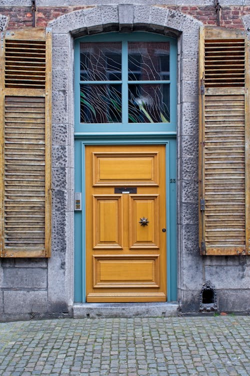 Yellow Door near Cobblestone Pavement