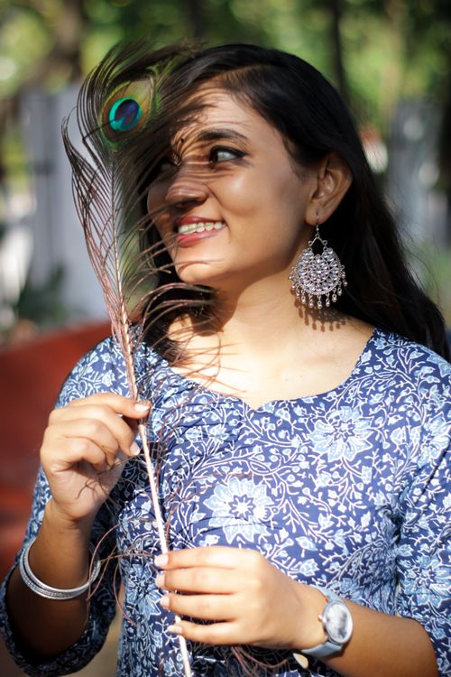 Portrait of Indian Woman Holding a Feather · Free Stock Photo