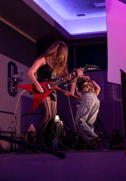 Women with Guitars Playing on Stage