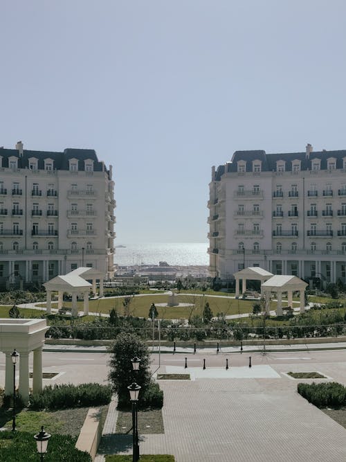 View of a Park and Apartment Buildings in City near the Sea 