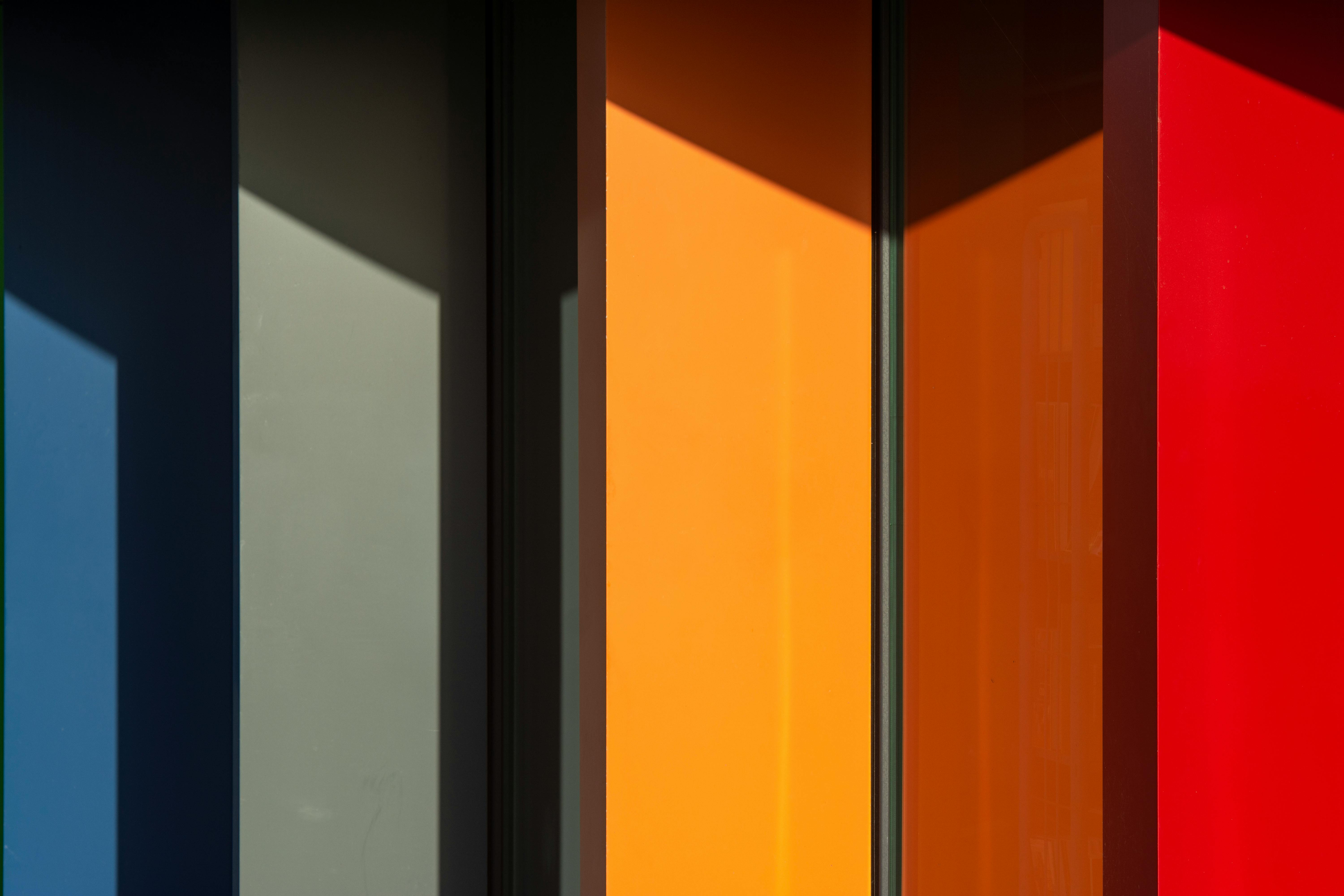 Colorful abstract wall of panels with bold shadows and geometric shapes.