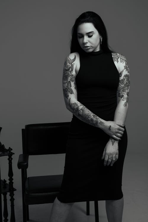 Woman With Tattoos Wearing a Long Dress in Black and White 