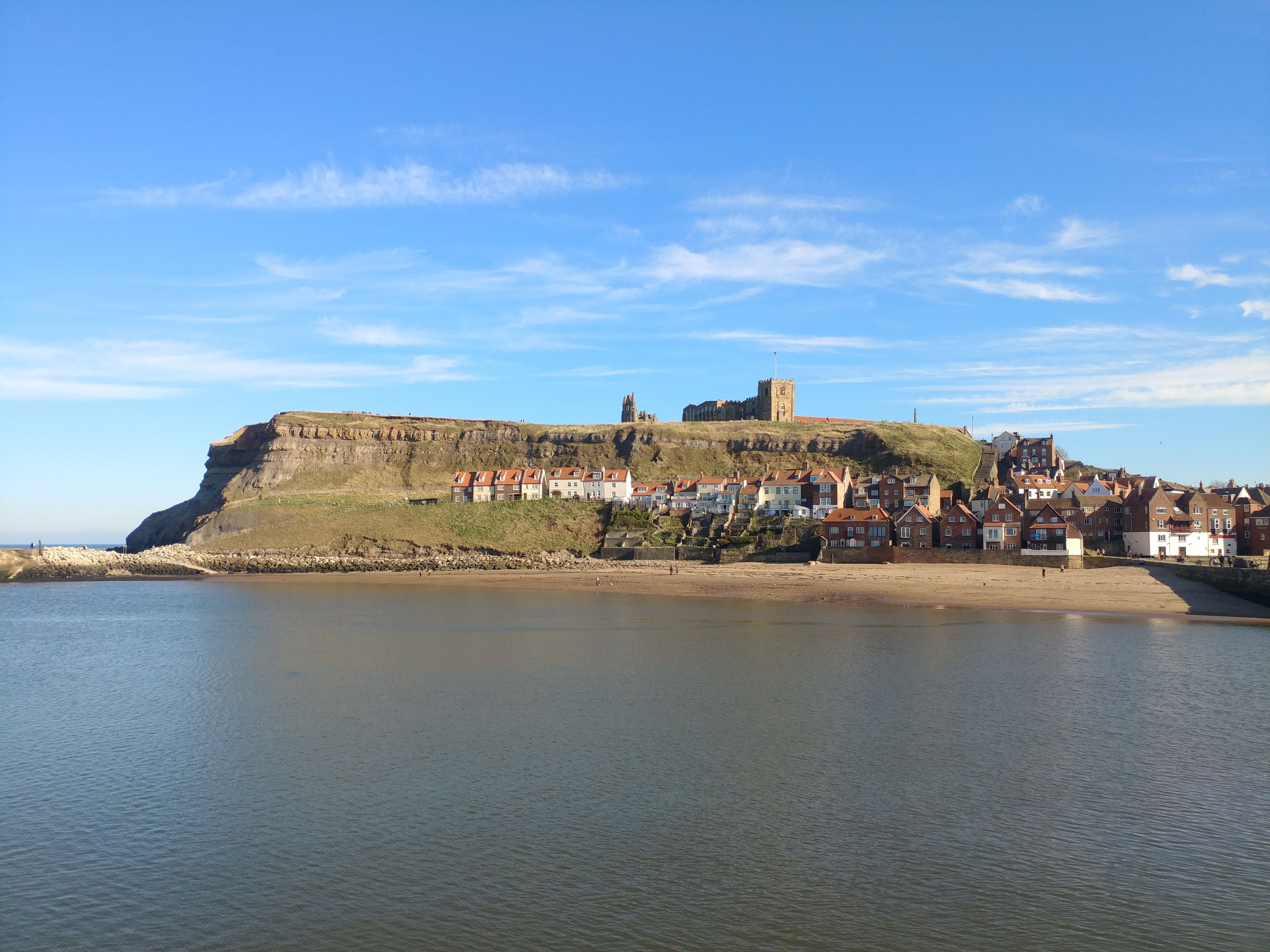 The ruined abbey above the red roofs and harbour of Whitby