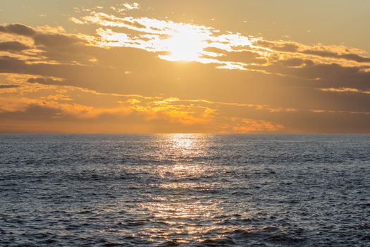 Breathtaking sunset over a tranquil ocean reflecting golden sunlight.
