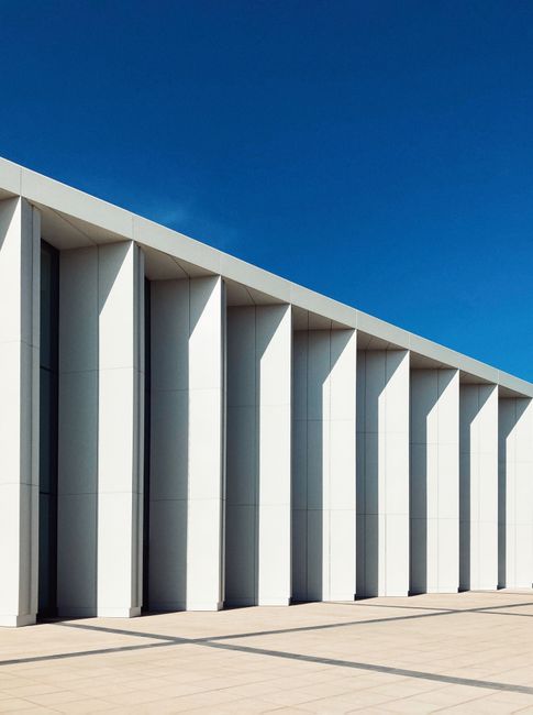 A striking modern architectural facade with vertical structures set against a clear blue sky in Nizhny Novgorod, Russia.