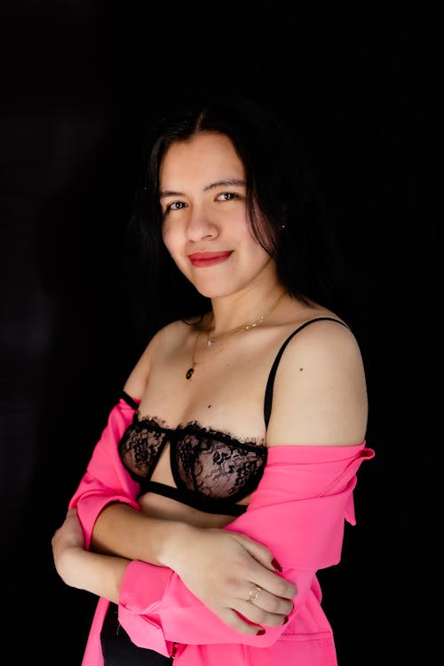 Woman in Lingerie Posing on Black Background