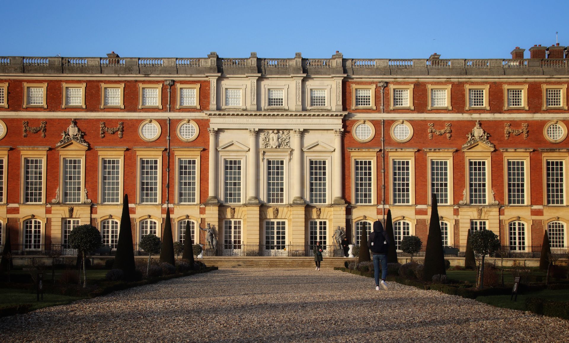 Stunning view of the Hampton Court Palace facade, showcasing baroque architecture and gardens in Molesey, England.