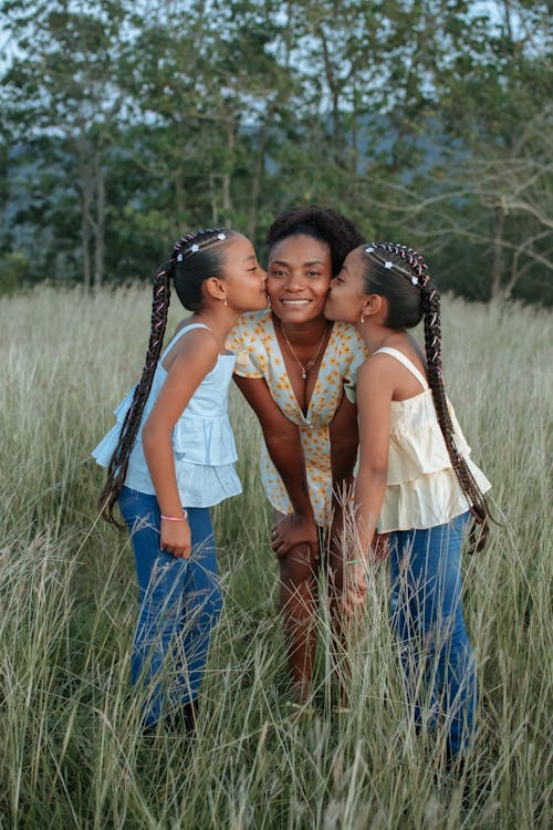 Daughters Kissing Mother