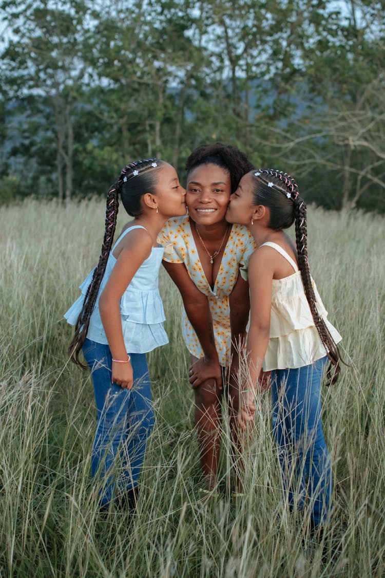 Daughters Kissing Mother