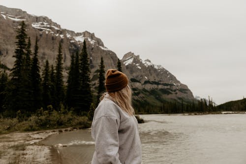 Woman Looking at a Scenic View of Mountains and River 