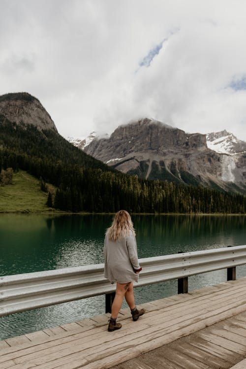 Woman on Footbridge over Mountain Lake