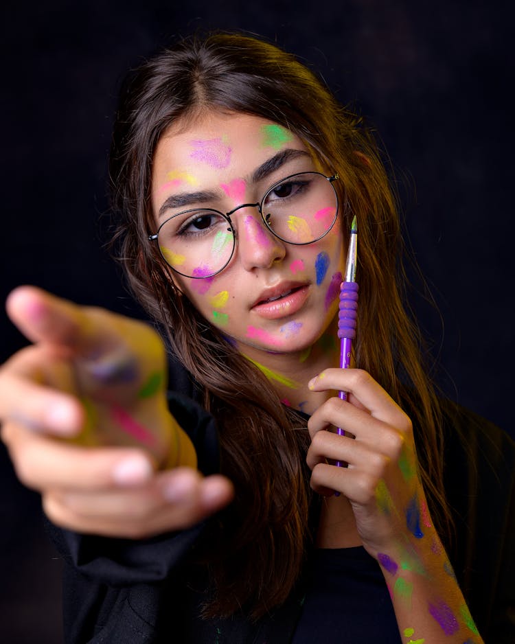 Woman With Eyeglasses And Paints On Face