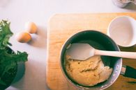 Pot With Spatula on Brown Chopping Board