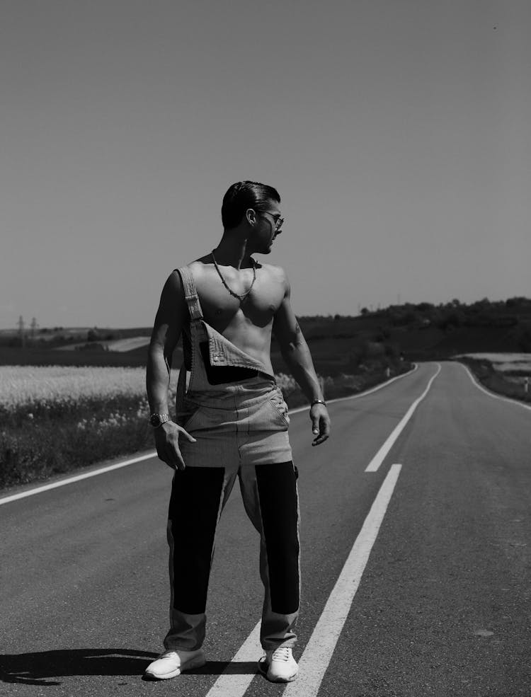 Man Wearing Overalls Standing On Empty Street