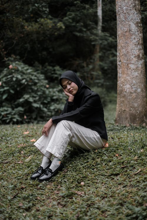 Woman Sitting under a Tree with her Eyes Closed 