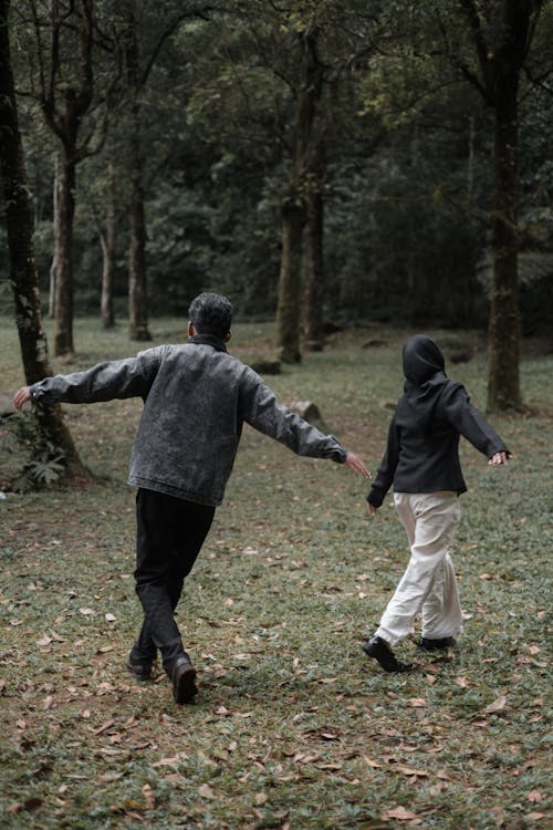 Man and Woman Running in Park