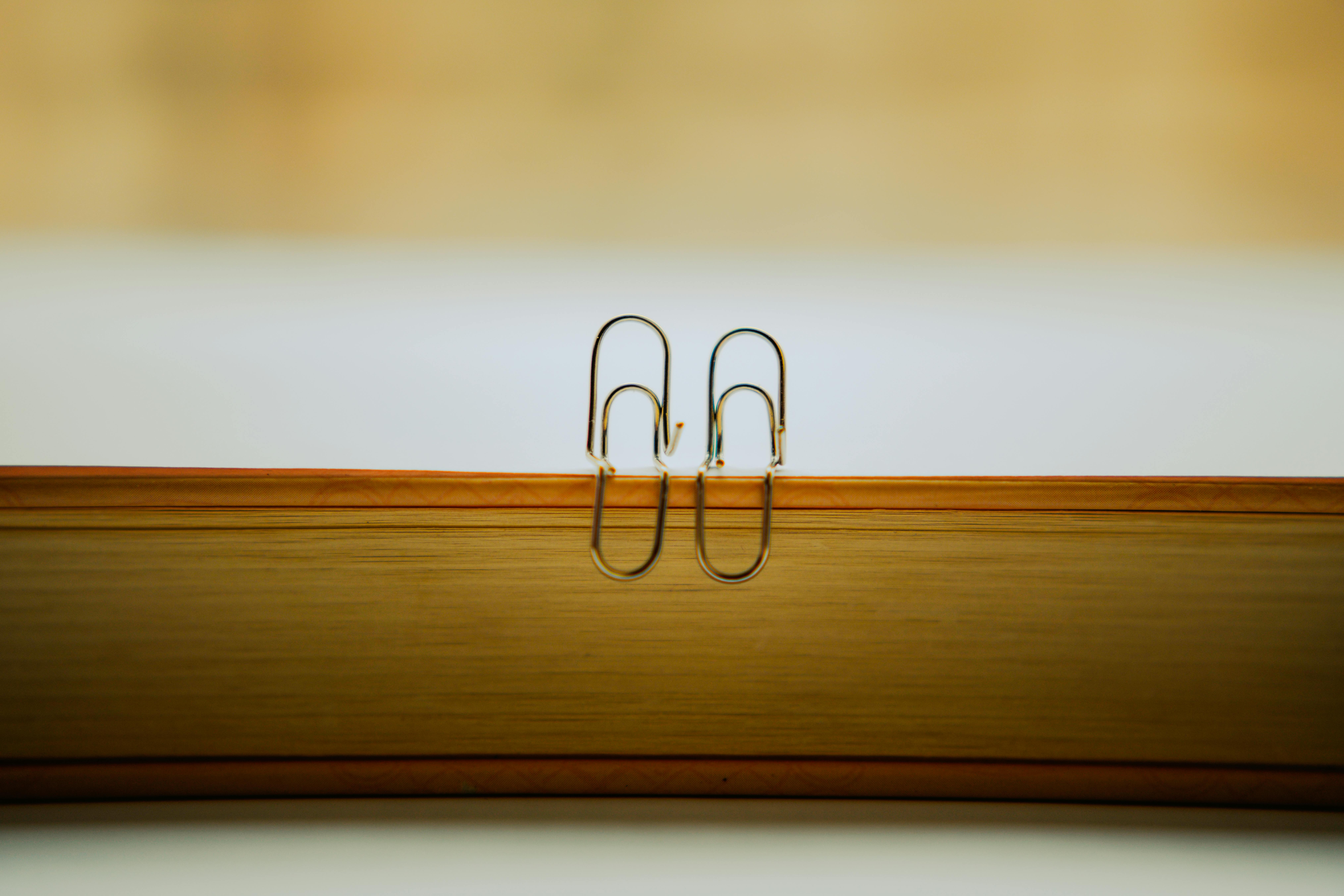 Two Paperclips on a Book · Free Stock Photo