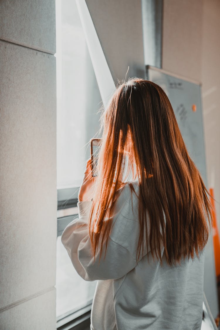 Woman Standing By Window