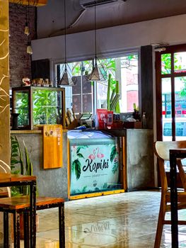 Inviting coffee shop interior with modern design, vibrant colors, and cozy seating arrangements.