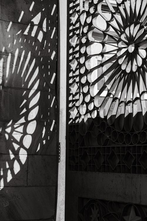 Free Intricate shadows create patterns on a wall, captured in elegant black and white. Stock Photo