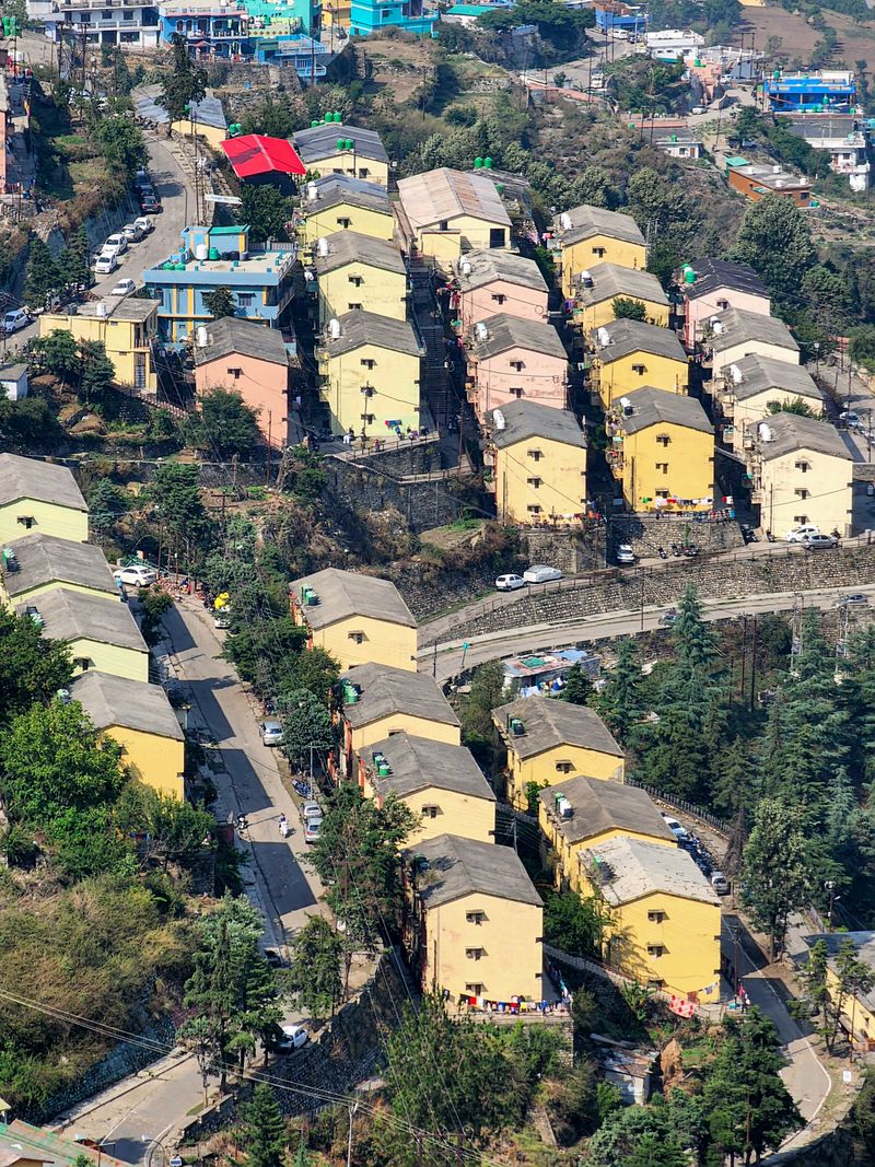 Aerial view showcasing vibrant residential buildings of New Tehri, India amidst lush greenery