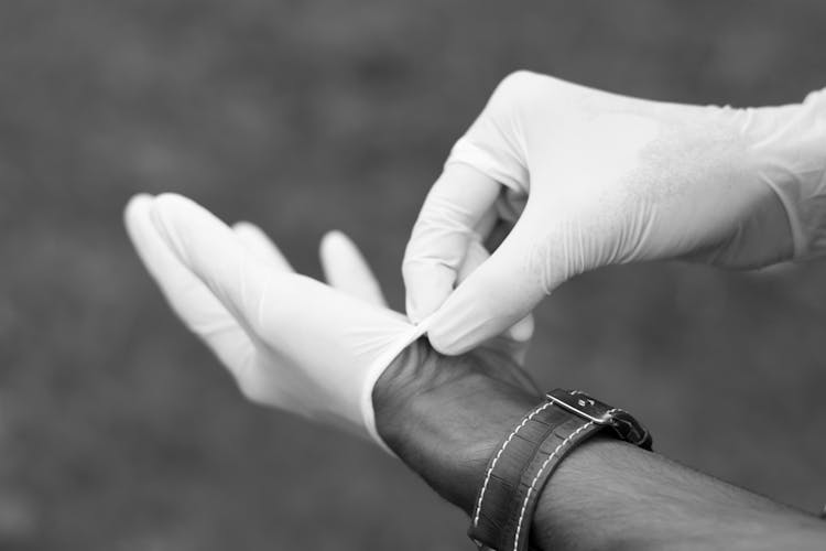 Man Putting On Rubber Gloves